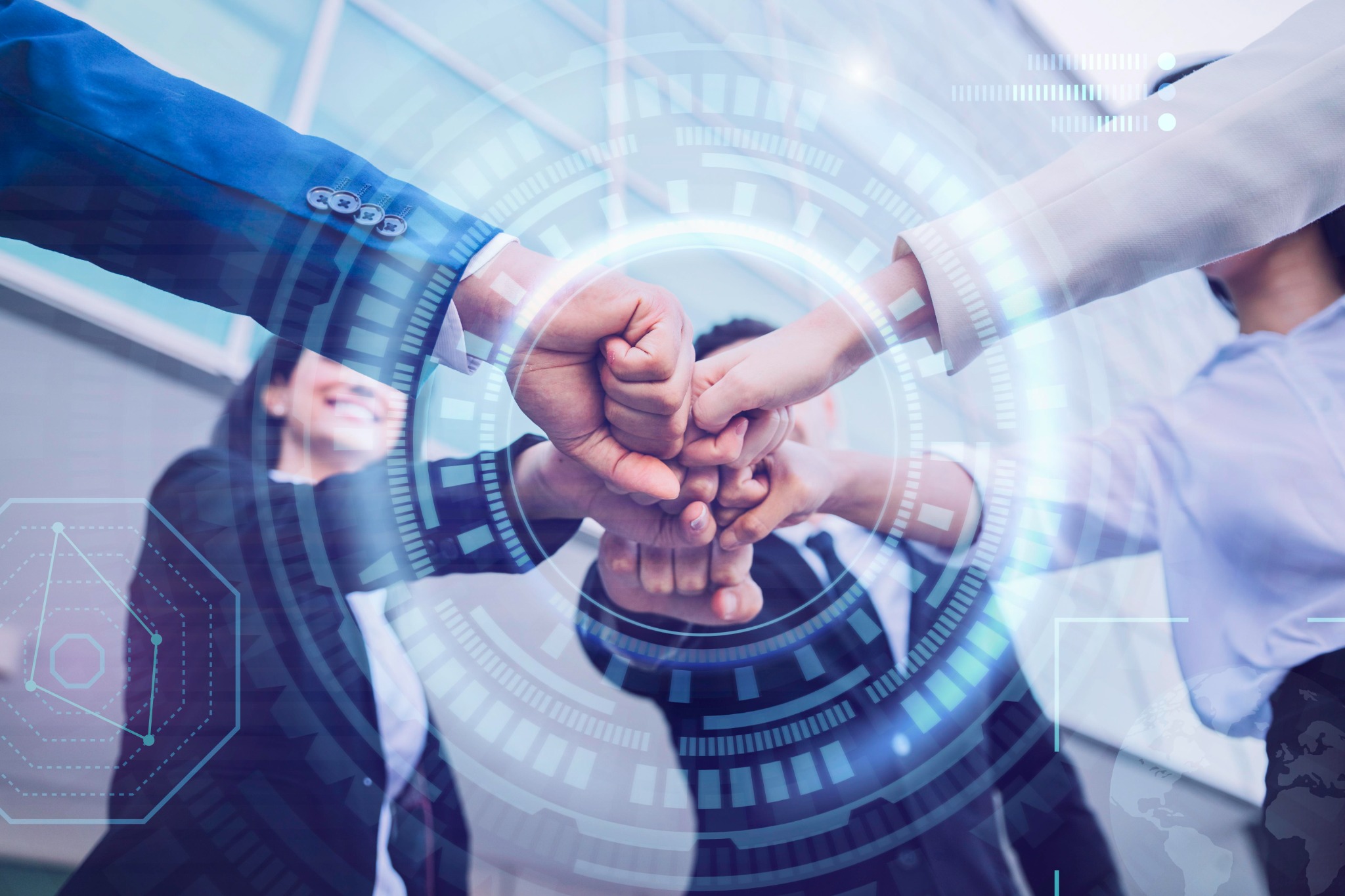 Team members joining hands with digital graphics